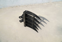 Rippa Australia black Excavator Rake attachment with curved tines on concrete floor