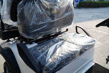 Close-up of a Golf Cart seat covered in protective plastic for safe transport and storage