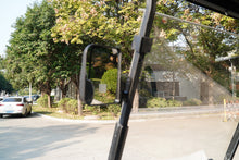 View from inside a Golf Cart showcasing trees and nearby vehicles on a sunny day